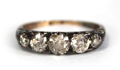 Lot 749 - An 18ct yellow gold ring set five small...