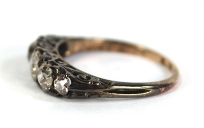 Lot 749 - An 18ct yellow gold ring set five small...