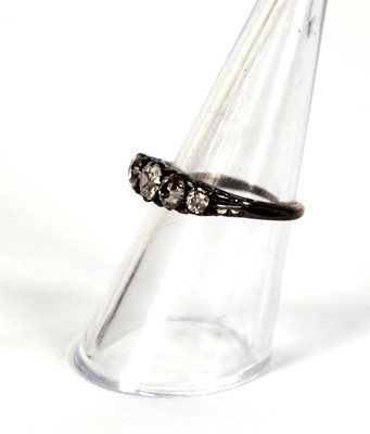 Lot 749 - An 18ct yellow gold ring set five small...