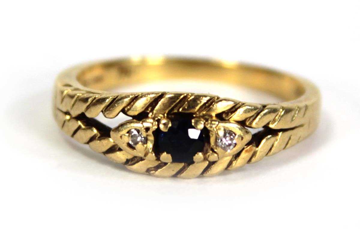 Lot 750 - An 18ct yellow gold ring set small sapphire...