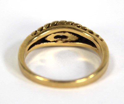 Lot 750 - An 18ct yellow gold ring set small sapphire...