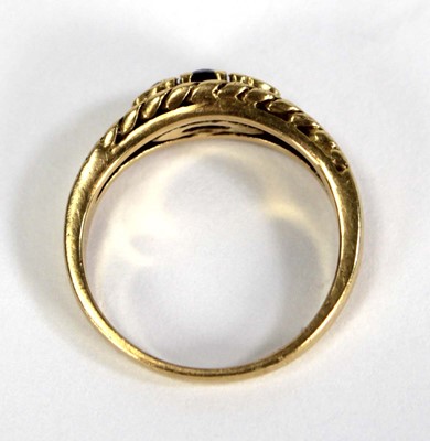 Lot 750 - An 18ct yellow gold ring set small sapphire...