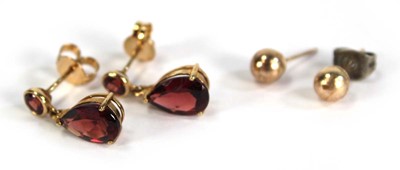 Lot 753 - A pair of 9ct yellow gold ear pendants set red...
