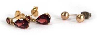 Lot 753 - A pair of 9ct yellow gold ear pendants set red...