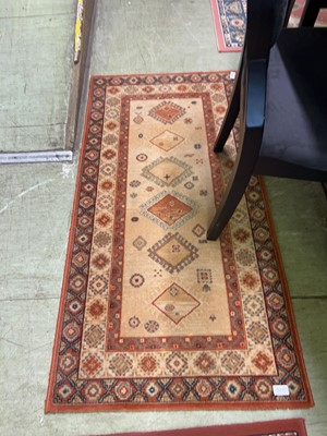 Lot 27 - Terracotta ground rug
