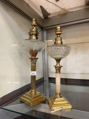 Lot 300 - A brass and glass corinthian columned oil lamp...