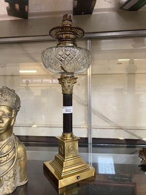 Lot 302 - A brass and cut glass Corinthian columned oil...
