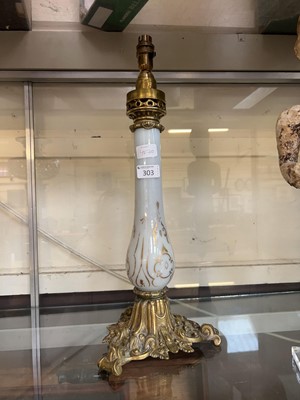 Lot 303 - A brass and milk glass table lamp with gilt...