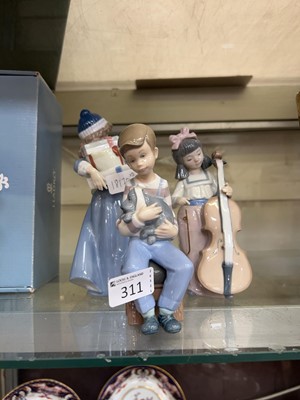 Lot 311 - Three Nao figurines of children