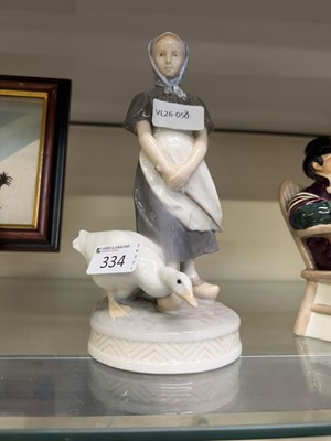 Lot 334 - A Royal Copenhagen figural group of lady with...
