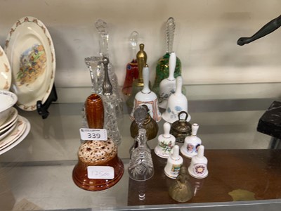 Lot 339 - An assortment of ceramic, glass, and brass bells