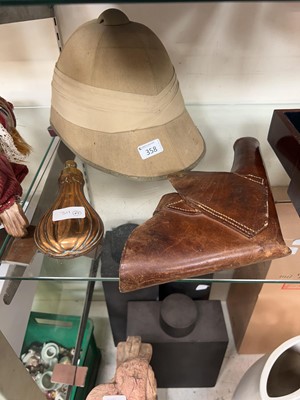 Lot 358 - A brass shot flask along with a leather...