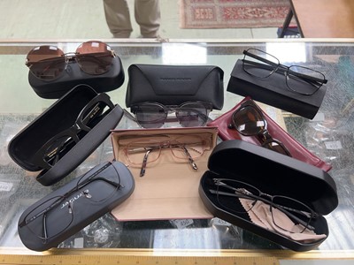 Lot 404 - A box containing assorted glasses and cases...