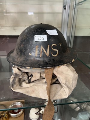 Lot 420 - A tin helmet along with kit bag