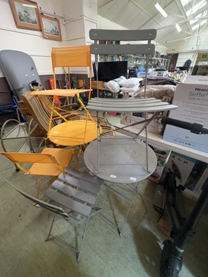 Lot 198 - A metal grey bistro table and two folding chairs