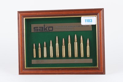 Lot 1103 - Framed and glazed Sako rifle cartridge display...