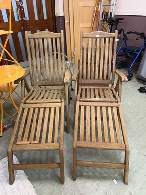 Lot 202 - Two teak folding garden sun loungers