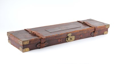 Lot 28 - Oak and leather shotgun case, red baize lined...