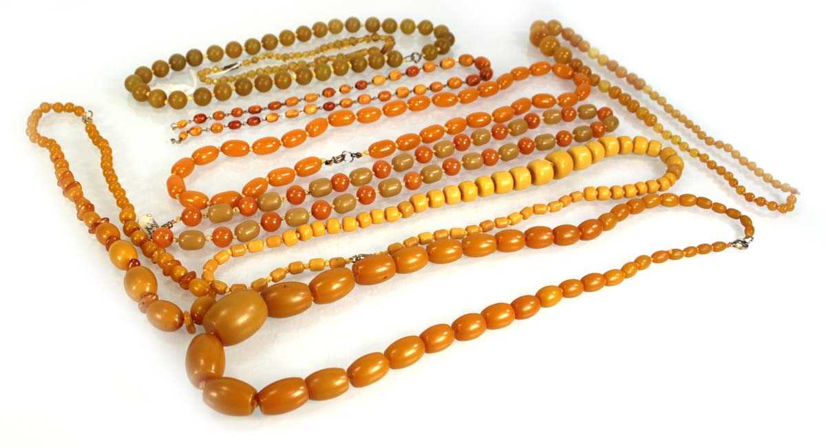 Lot 772 - Nine butterscotch amber-style and costume...