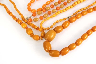 Lot 772 - Nine butterscotch amber-style and costume...