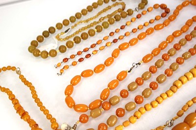 Lot 772 - Nine butterscotch amber-style and costume...