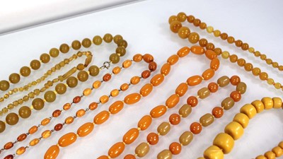 Lot 772 - Nine butterscotch amber-style and costume...