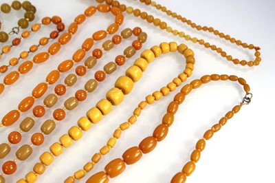 Lot 772 - Nine butterscotch amber-style and costume...