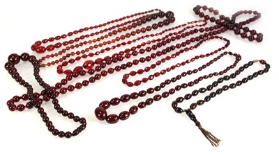 Lot 773 - Nine cherry amber-style and costume necklaces (9)