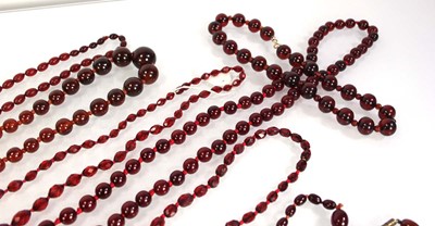 Lot 773 - Nine cherry amber-style and costume necklaces (9)