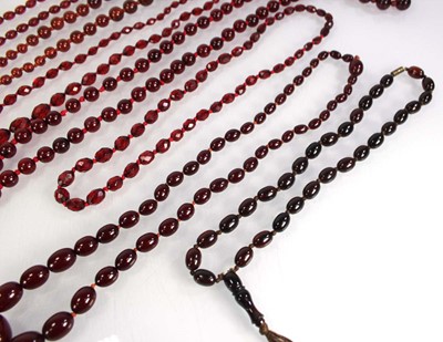 Lot 773 - Nine cherry amber-style and costume necklaces (9)