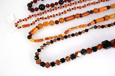 Lot 775 - Four amber-style and costume necklaces (4)