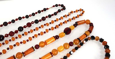 Lot 775 - Four amber-style and costume necklaces (4)