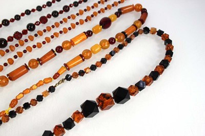 Lot 775 - Four amber-style and costume necklaces (4)