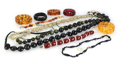 Lot 776 - Seven amber-style and costume bracelets and...
