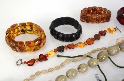 Lot 776 - Seven amber-style and costume bracelets and...
