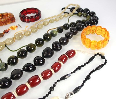 Lot 776 - Seven amber-style and costume bracelets and...