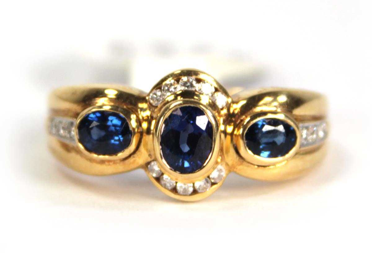 Lot 780 - An 18ct yellow gold ring set three oval...