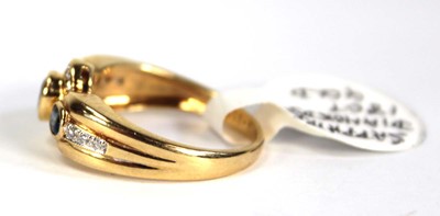Lot 780 - An 18ct yellow gold ring set three oval...