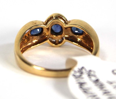 Lot 780 - An 18ct yellow gold ring set three oval...