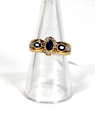 Lot 780 - An 18ct yellow gold ring set three oval...