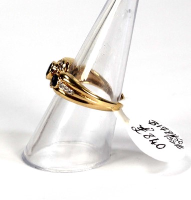 Lot 780 - An 18ct yellow gold ring set three oval...