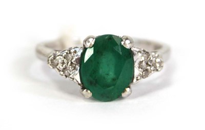 Lot 783 - A 9ct white gold ring set oval emerald and...