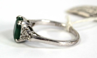 Lot 783 - A 9ct white gold ring set oval emerald and...