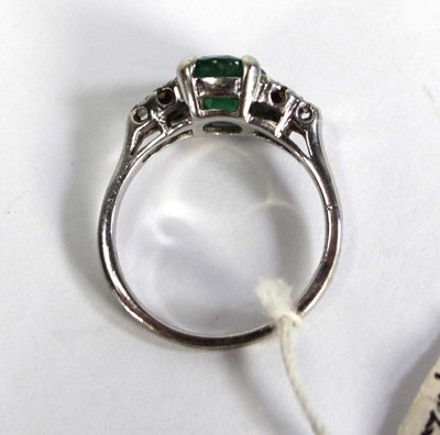 Lot 783 - A 9ct white gold ring set oval emerald and...