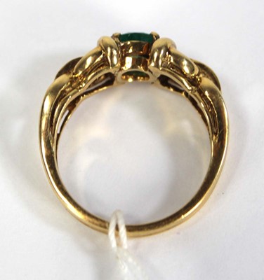 Lot 784 - An 18ct yellow gold ring set oval emerald and...
