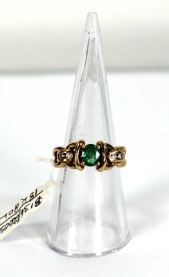Lot 784 - An 18ct yellow gold ring set oval emerald and...