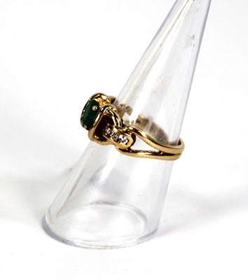 Lot 784 - An 18ct yellow gold ring set oval emerald and...