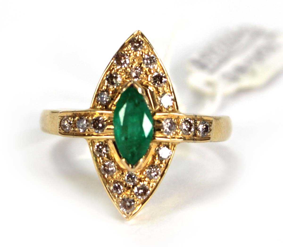 Lot 785 - An 18ct yellow gold ring set emerald and small...