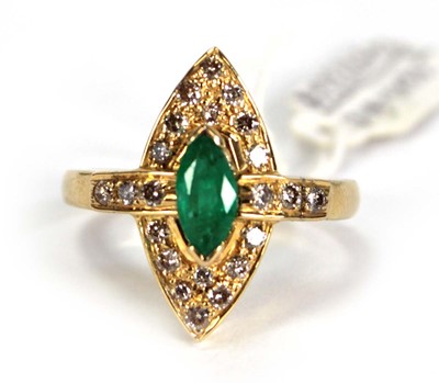 Lot 785 - An 18ct yellow gold ring set emerald and small...