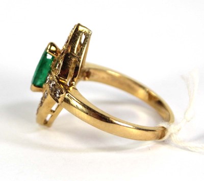 Lot 785 - An 18ct yellow gold ring set emerald and small...